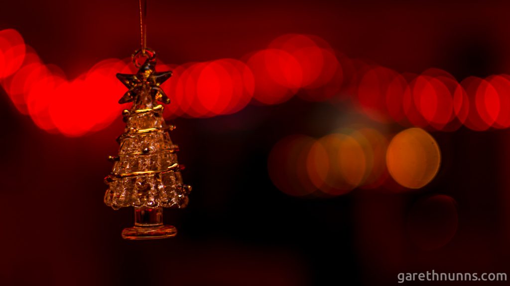 Christmas tree decoration with blurred Christmas lights behind