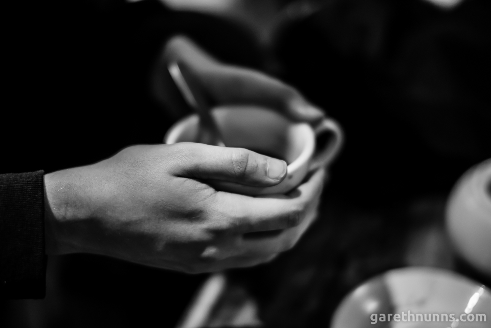 Holding coffee cup in hands in black and white