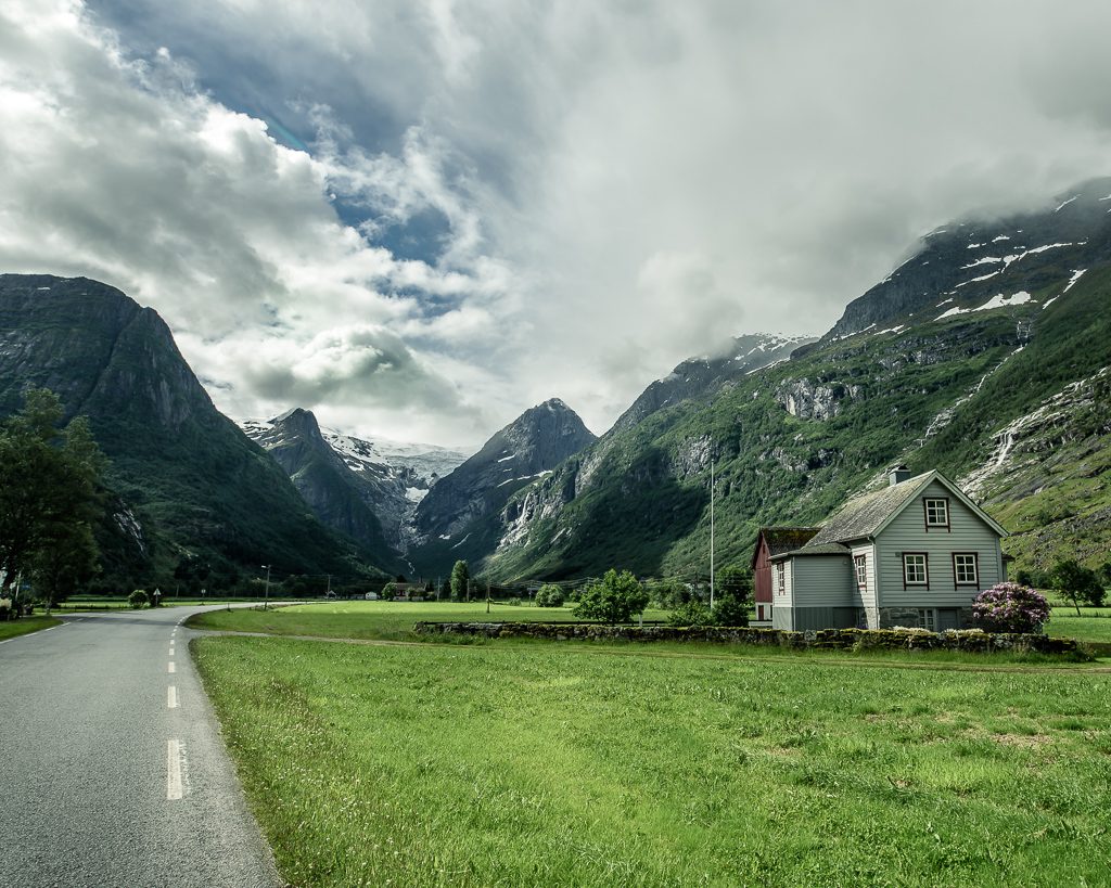 Isolated Norwegian house in a fjord between Olden and Briksdalsbreen on an empty road