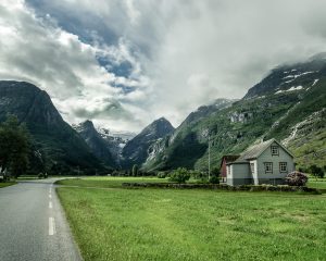 Isolated Norwegian house in a fjord between Olden and Briksdalsbreen on an empty road